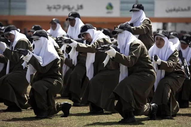 Female members of Palestinian security forces loyal to Hamas show their skills during a military graduation ceremony in Gaza City on April 2, 2014. The Hamas-ruled Gaza Strip has been under blockade since 2006, after militants captured an Israeli soldier in a cross-border raid. (Photo by Mohammed Abed/AFP Photo)