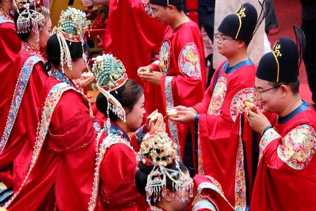 Couples dressed in traditional costumes take part in a group wedding in Shiyan, central China's Hubei Province, May 20, 2024. Ten couples participated in a group wedding here on Monday. (Photo by Xinhua News Agency/Rex Features/Shutterstock)
