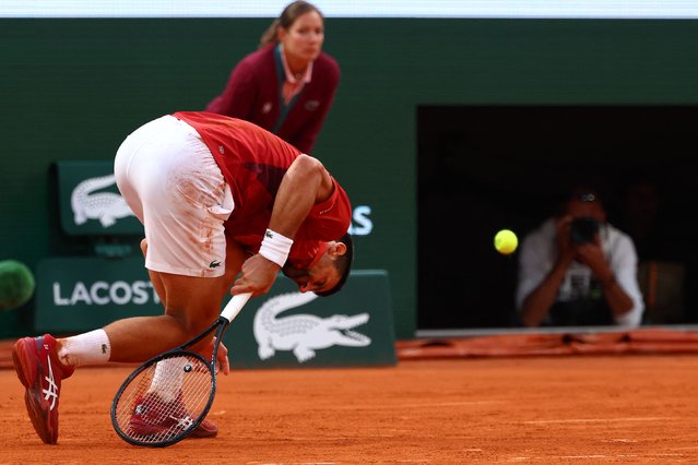 Serbia's Novak Djokovic falls on the court during his men's singles round of sixteen match against Argentina's Francisco Cerundolo on Court Philippe-Chatrier on day nine of the French Open tennis tournament at the Roland Garros Complex in Paris on June 3, 2024. (Photo by Emmanuel Dunand/AFP Photo)