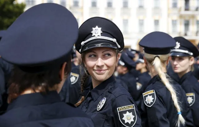 Police officers wait before an oath-taking ceremony to start up the work of a new police patrol service, part of the Interior Ministry reform initiated by Ukrainian authorities, in Kiev, Ukraine, July 4, 2015. (Photo by Valentyn Ogirenko/Reuters)