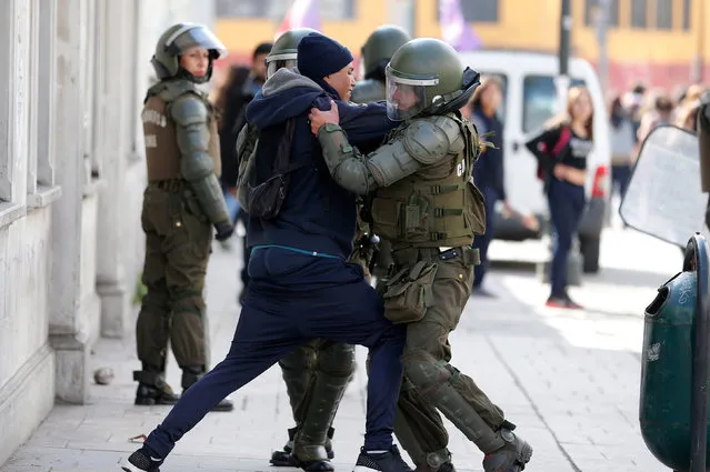 A student is detained by riot police during a demonstration to demand changes in the education system in Valparaiso city, Chile, May 5, 2016. (Photo by Rodrigo Garrido/Reuters)
