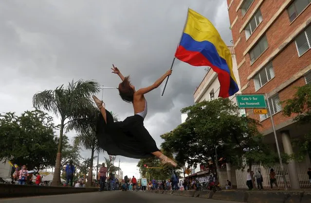 A ballet dancer participates in a protest in front of the hotel where IACHR delegates receive testimonies from victims during the National Strike, in Cali, Colombia, 08 June 2021. The Inter-American Commission on Human Rights (IACHR) began its three-day working visit to several Colombian cities on 08 June where it will collect testimonies of human rights violations during the protests. (Photo by Ernesto Guzmán Jr./EPA/EFE)