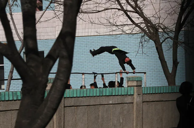 A North Korean student swings on a bar in a school in Pyongyang, North Korea, 12 April 2017. China's President Xi Jinping called for a “peaceful” resolution as tensions rose over North Korea in a phone call to US President Donald Trump, according to Chinese media on 12 April 2017. (Photo by How Hwee Young/EPA)
