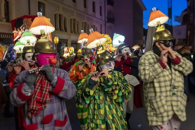 Members of carnival marching bands in costumes parade through the streets during the so-called “Morgestraich” carnival parade in Basel, Switzerland, on Monday, early 07 March 2022. The traditional “Morgenstraich” parade with colorful lanterns and revelers in traditional costumes is starting early morning at 4 a.m. and marks the kick-off for the Basel carnival. It was not held in its usual form in the past two years because of the measures against the Covid-19 pandemic. (Photo by Georgios Kefalas/EPA/EFE)