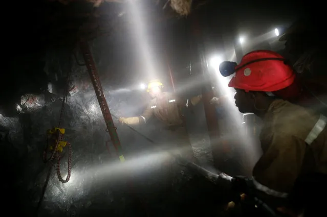 Mine workers employed at Sibanye Gold's Masimthembe shaft operate a drill in Westonaria, South Africa, April 3, 2017. (Photo by Mike Hutchings/Reuters)