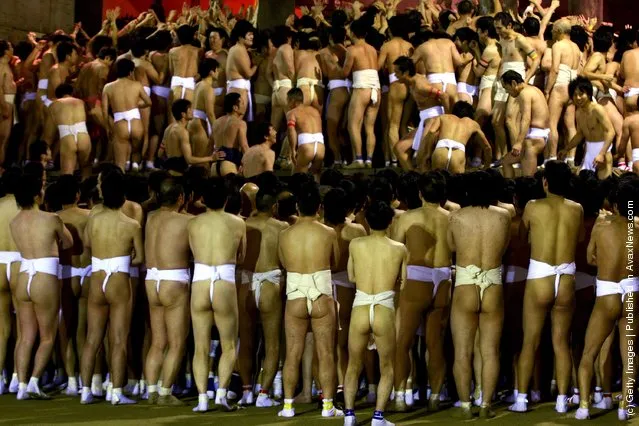 Japanese men wear loincloths as they  try to enter the Saidaiji Temple during Naked Festival