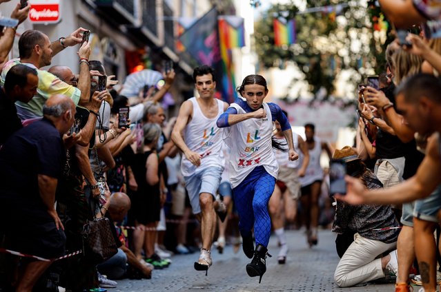 Participants compete in the High-Heels Race as part of the Pride celebrations, in the Chueca neighbourhood in Madrid on July 4 29, 2024. MADO (Madrid Pride) is a series of street celebrations that take place during the city´s LGBTIQ (lesbian, gay, bisеxual, transgender, intersеx and queer) Pride week. (Photo by Oscar del Pozo/AFP Photo)