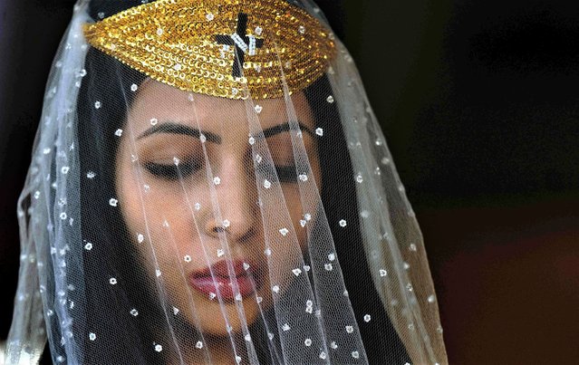 A Nymph or female devotee of the Vale do Amanhecer religious community, prays at their temple complex in Vale do Amanhecer (Sunrise Valley), a community on the outskirts of Planaltina, 50 km from the Brazilian capital, Brasilia, on April 29, 2023. This eclectic community holds its most important ritual of the year on Labour Day to honour the mediums who communicate with good and bad spirits. The group combines a range of religious practices, including Christian and Hindu, with symbols borrowed from the Incas and Mayans, as well as a belief in extraterrestrial life and intergalactic travel. The religion claims hundred temples throughout Brazil, Portugal and other countries. (Photo by Carl de Souza/AFP Photo)