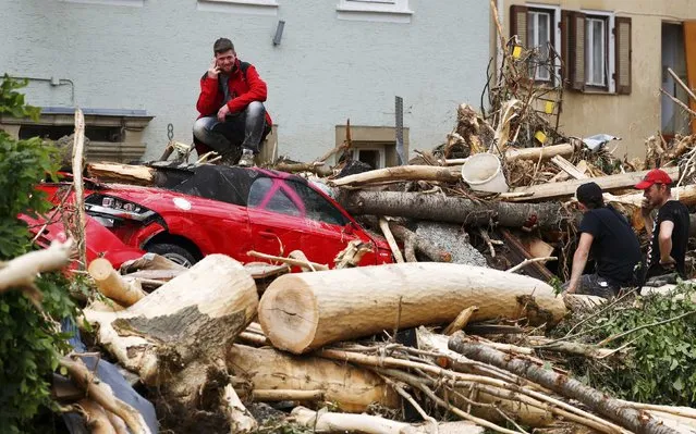 People inspect the damage caused by the floods in the town of Braunsbach, in Baden-Wuerttemberg, Germany, May 30, 2016. (Photo by Kai Pfaffenbach/Reuters)