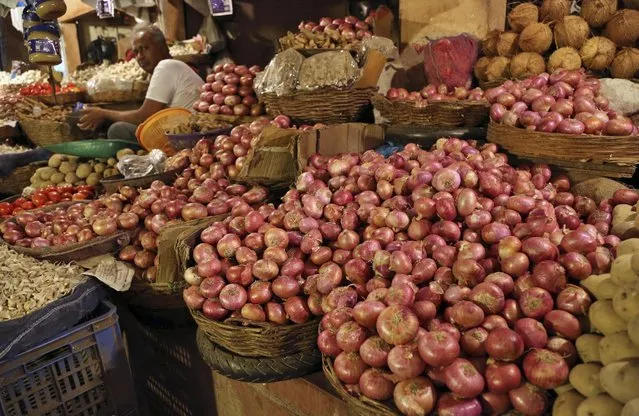 Onions are displayed for sale at a roadside vegetable stall in Bangalore, India, Thursday, July 23, 2015. Wholesale prices for onions at Lasalgoan in Maharashtra state, Asia's biggest market for this kitchen staple, has jumped to its highest in nearly two years due to weak monsoon rains. (Photo by Aijaz Rahi/AP Photo)