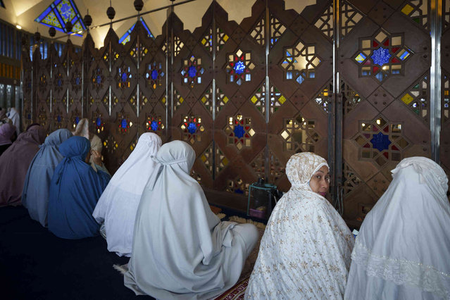 Muslims attend prayers at National Mosque for the Eid al-Fitr, marking the end the holy fasting month of Ramadan in Kuala Lumpur, Malaysia, Wednesday, April 10, 2024. (Photo by Vincent Thian/AP Photo)