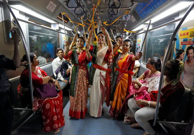 Women, who according to the organisers are suffering from Thalassaemia, perform inside a running Metro train to celebrate the 158th birth anniversary of Nobel Prize winning poet Rabindranath Tagore in Kolkata, India, May 9, 2019. (Photo by Rupak De Chowdhuri/Reuters)