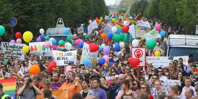 People hold flags and balloons as they take part in the gay rights “Baltic Pride 2016” march on June 17, 2016, in Vilnius. (Photo by Petras Malukas/AFP Photo)