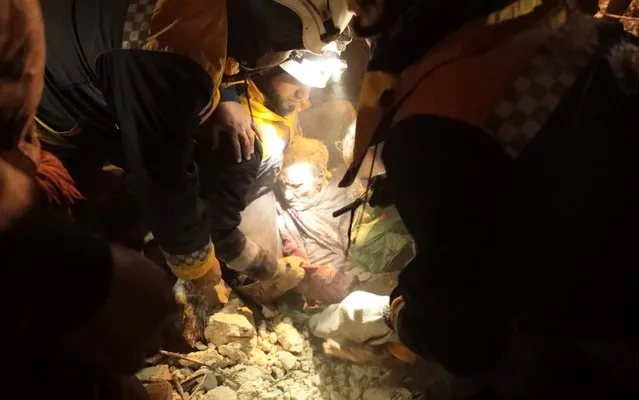 Members of the Syrian Civil Defence, also known as the White Helmets, recover a man from the rubble of a building following a reported airstrike on the village of Kafr Nuran, in the western countryside of the northern province of Aleppo, on January 21, 2020. Russian air strikes killed at least 15 civilians in northwestern Syria, as renewed violence tightened the noose around the country's last major rebel-held bastion and deepened an already dire humanitarian crisis. (Photo by Aaref Watad/AFP Photo)