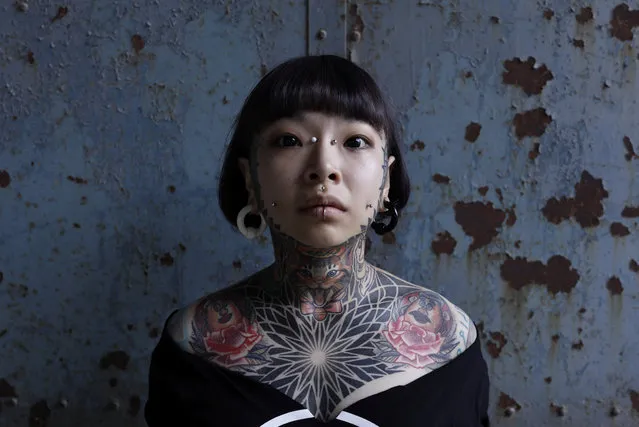 A tattooed woman poses at Taipei International Tattoo & Music Festival in Taipei, Taiwan July 9, 2017. (Photo by Tyrone Siu/Reuters)