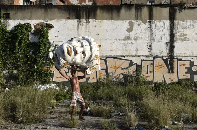 People collect dismantled and damaged objects to recycle them at a samba schools' garbage as the samba school parades were canceled due to the coronavirus (Covid-19) pandemic  which killed total of 605.804 people in the country, on October 25, 2021 in Rio De Janerio, Brazil. (Photo by Fabio Teixeira/Anadolu Agency via Getty Images)