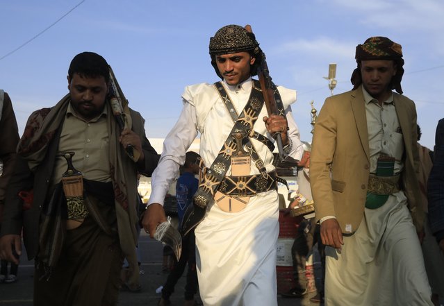 A groom (C) in a traditional wedding attire performs traditional dances following a group photoshoot at a square in Sana'a, Yemen, 19 June 2024. A Yemeni groom and his male relatives and friends gather at a square in Sana'a for a group photoshoot, as part of a new social practice, at least a month before the actual marriage date. The groom carrying a gun wears traditional wedding attire and a dagger. Following the group photo shoot, the groom and his companions perform traditional dances. (Photo by Yahya Arhab/EPA)