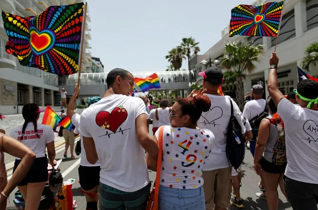 A participant wears a shirt with the number 49 for the number of victims of the Pulse night club shooting in Orlando, during the annual gay pride parade in San Juan, Puerto Rico, June 26, 2016. (Photo by Alvin Baez/Reuters)