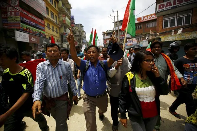 Protesters chant slogans as they march on a road during a general strike organised by a 30-party alliance led by a hardline faction of former Maoist rebels, who are protesting against the draft of the new constitution, in Kathmandu, Nepal August 16, 2015. (Photo by Navesh Chitrakar/Reuters)