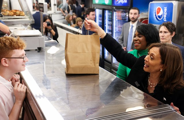 Democratic presidential nominee U.S. Vice President Kamala Harris holds a bag at the Famous 4th Street Delicatessen in Philadelphia, Pennsylvania on October 23, 2024. (Photo by Kevin Mohatt/Reuters)