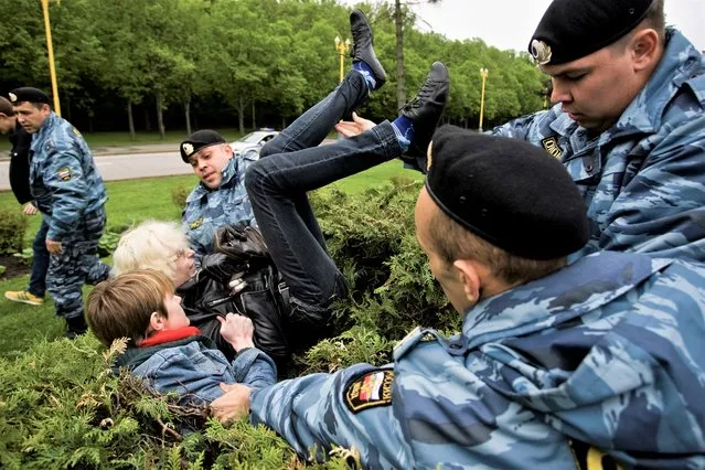A Russian Gay Rights protester is taken away by riot police officers in Moscow, Russia, Saturday, May 16, 2009. Russia passed a law in 2013 that bans the depiction of homosexuality to minors, something human rights groups views as a way to demonize LGBT people and discriminate against them. (Photo by Roustem Adagamov/AP Photo/File)
