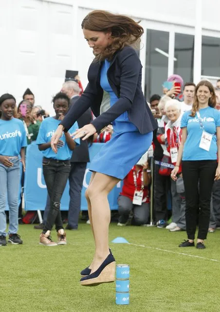 Britain's Catherine, Duchess of Cambridge plays South African games “Three Tins” during a visit to the Commonwealth Games Village at the 2014 Commonwealth Games in Glasgow, Scotland July 29, 2014. (Photo by Danny Lawson/Reuters)