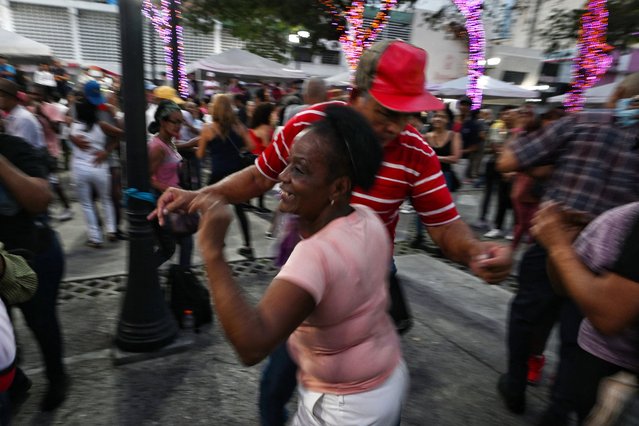 An elderly couple dances salsa at the El Venezolano Square in downtown Caracas on October 13, 2024. (Photo by Juan Barreto/AFP Photo)