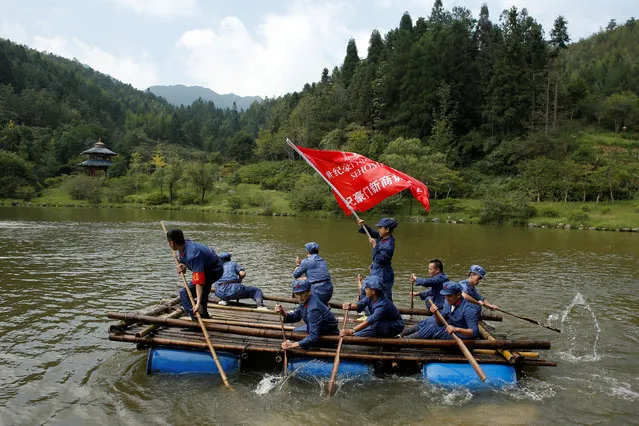 Participants dressed in replica red army uniforms row a raft across a lake during a Communist team-building course extolling the spirit of the Long March, organised by the Revolutionary Tradition College, in the mountains outside Jinggangshan, Jiangxi province, China, September 14, 2017. (Photo by Thomas Peter/Reuters)