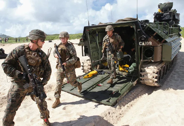 U.S. Marines exit an amphibious assault vehicle during a simulated beach assault at Marine Corps Base Hawaii with the 3rd Marine Expeditionary Unit during the multi-national military exercise RIMPAC in Kaneohe, Hawaii, July 30, 2016. (Photo by Hugh Gentry/Reuters)