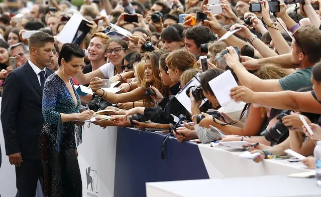 French actress Juliette Binoche signs autographs during the red carpet event for the movie “L'Attesa” (The Wait) at the 72nd Venice Film Festival, northern Italy September 5, 2015. (Photo by Stefano Rellandini/Reuters)