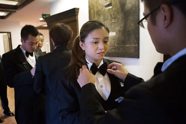 Butlery students make final preparations before an inspection of their uniforms at The International Butler Academy China on September 16, 2014 in Chengdu, China. (Photo by Taylor Weidman/Getty Images)