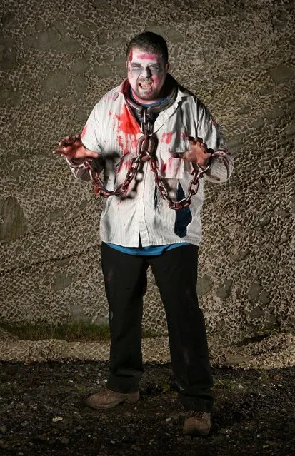 A visitor to the Shocktober Fest dressed as a zombie poses on October 6, 2012 in Turners Hill, England. People dressed as zombies from around the United Kingdom have converged on Tulleys Farm in an attempt to set a new Guinness World Record for the most zombies together in one place.  (Photo by Peter Macdiarmid)