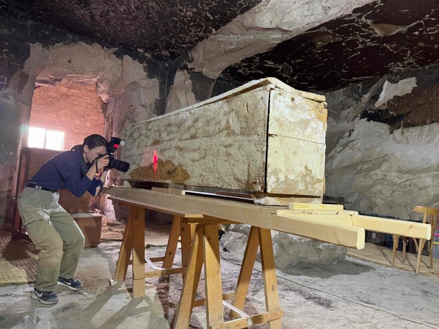This handout photo released on December 29, 2024, from the Universtity of Strasbourg and the French Institute for Oriental Archaeology (Institut francais d'archeologie orientale –IFAO) shows an archaeologist taking 3D measurements of an Ancient Egyptian Middle Kingdom sarcophagus discovered in Luxor. Researchers have uncovered a re-inhumed Middle Kingdom sarcophagus in Luxor, Egypt, as part of investigations carried out following the discovery, in 2018 and 2019, of sarcophagi on the same site, a member of the mission said on December 29, 2024. The discovery was made on December 16, 2024, at the very end of a two-month mission, the director of the University of Strasbourg's Institute of Egyptology, who took part in the mission, confirmed to AFP, confirming a report in the regional daily Les Dernieres Nouvelles d'Alsace (DNA). (Photo by Frederic Colin/AFP Photo)