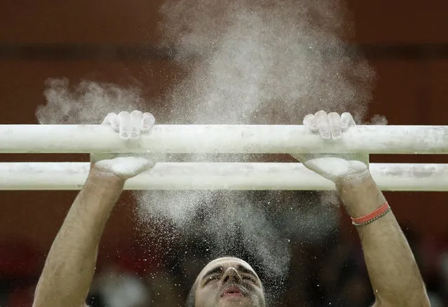 United States' Danell Leyva prepares for his performance on the parallel bars during the gymnastics exhibition gala at the 2016 Summer Olympics in Rio de Janeiro, Brazil, Wednesday, August 17, 2016. (Photo by Dmitri Lovetsky/AP Photo)