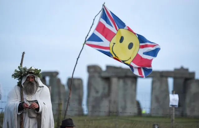 Druid Merlin at Stonehenge as the sun sets ahead of Summer Solstice on June 20, 2020 in Amesbury, United Kingdom. English Heritage, which manages the site, said “Our priority is always to ensure the safety and wellbeing of staff, volunteers, attendees and residents. The decision to remain closed for Summer Solstice 2020 was made due to the on-going ban on mass gatherings and the need to maintain social distancing – still the mainstay of measures to combat Coronavirus. Before making this decision we consulted widely with partners, including Wiltshire Council, the police, ambulance services and Avebury Parish Council”. (Photo by Finnbarr Webster/Getty Images)