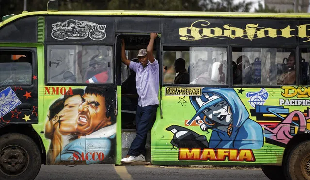 The conductor of a “matatu” public minibus looks out as supporters of opposition leader Raila Odinga attempt to demonstrate in downtown Nairobi, Kenya Tuesday, October 24, 2017. (Photo by Ben Curtis/AP Photo)