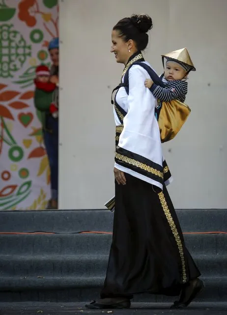 A participant walks on a stage during the best design baby carrier competition, in the southern city of Stavropol, Russia, September 20, 2015. (Photo by Eduard Korniyenko/Reuters)