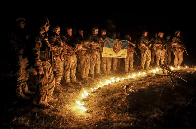 A handout photo made available by the press service of the 24th Mechanized Brigade of the Ukrainian Armed Forces on 24 March 2025 shows servicemen of the 24th Mechanized Brigade named after King Danylo receiving brigade coins following military training at an undisclosed location in the Donetsk region, eastern Ukraine, 21 March 2025, amid the Russian invasion. (Photo by 24th Mechanized Brigade Press Service/EPA)