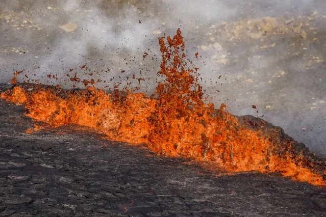 A close-up of the lava flowing from Fagradalsfjall volcano in Iceland on Wednesday August 3, 2022, which is located 32 kilometers (20 miles) southwest of the capital of Reykjavik and close to the international Keflavik Airport. Authorities in Iceland say the volcano in the southwest of the country is erupting just eight months after its last eruption officially ended. (Photo by Marco Di Marco/AP Photo)