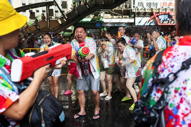 Revellers play with water as they celebrate the Songkran holiday, which marks the Thai New Year, in Bangkok, Thailand, on April 13, 2025. (Photo by Chalinee Thirasupa/Reuters)