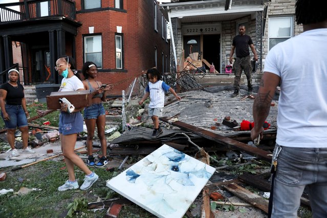 A young child walks across fallen debris as residents inspect their houses, after the tornado in St. Louis, Missouri, on May 16, 2025. (Photo by Lawrence Bryant/Reuters)