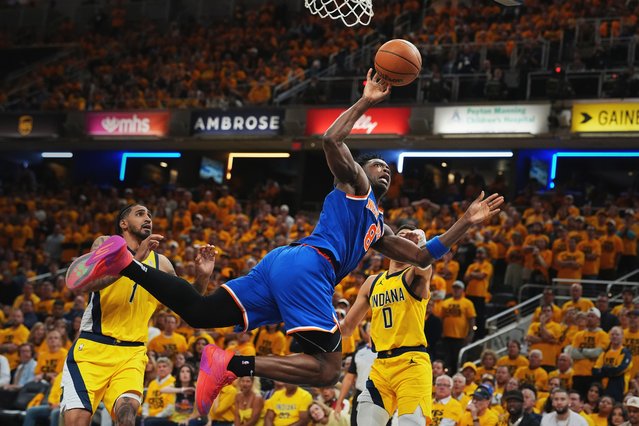 New York Knicks forward OG Anunoby (8) shoots the ball past Indiana Pacers forward Obi Toppin (1) and guard Tyrese Haliburton (0) during the second half of Game 4 of the Eastern Conference finals of the NBA basketball playoffs in Indianapolis, Tuesday, May 27, 2025. (Photo by Michael Conroy/AP Photo)