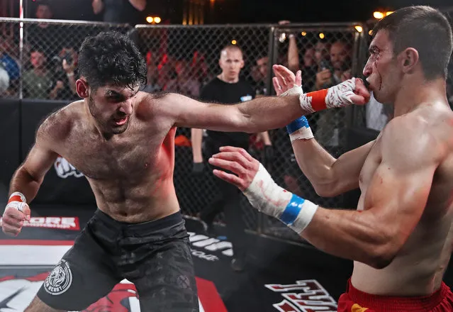 Sportsmen Emil Bakhshiyev (L) and Mukhamed Kalmykov compete in a bout during the Round of 16 of the Hardcore Fighting Championship aboard the Rio-1 ship in Moscow, Russia on August 31, 2020. Hardcore Fighting Championship is the first Russian professional bare-knuckle fighting league, with the main prize of 1 mln roubles. (Photo by Valery Sharifulin/TASS)