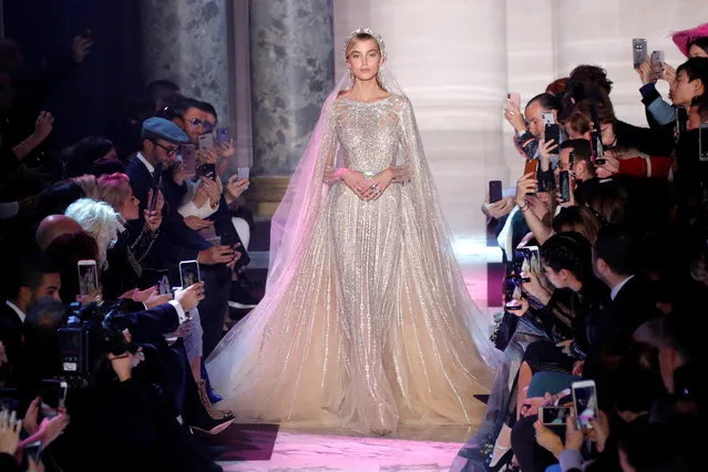 A model presents a wedding dress by designer Elie Saab as part of his Haute Couture Spring-Summer 2018 fashion show in Paris, France on January 24, 2018. (Photo by Charles Platiau/Reuters)