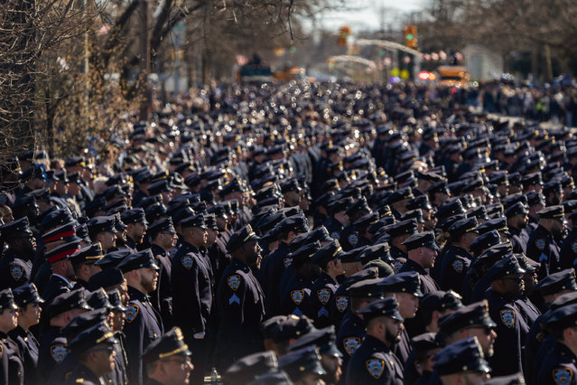 Police officers gather during a funeral service for New York City police officer Jonathan Diller, oiutside the Saint Rose of Lima R.C Church in Massapequa Park, N.Y., March 30, 2024. Diller, 31, who was shot dead during a traffic stop, was the first New York City police officer killed in the line of duty in two years. (Photo by Jeenah Moon/AP Photo)