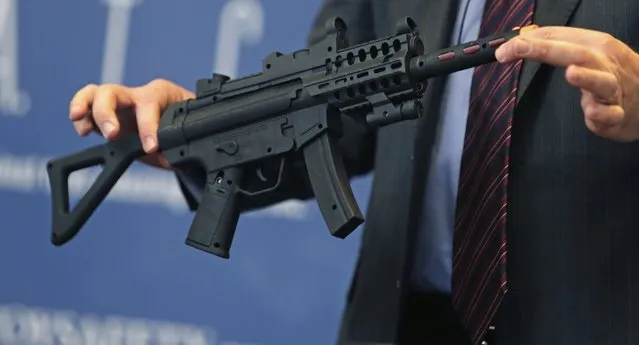 James Swartz, director of World Against Toys Causing Harm Inc., holds up toy machine gun at Children's Franciscan Hospital in Boston, Wednesday, November 19, 2014. (Photo by Charles Krupa/AP Photo)