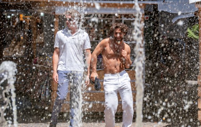 People cool off during the heatwave in Catania, Italy on July 21, 2025. (Photo by Marco Restivo/Reuters)
