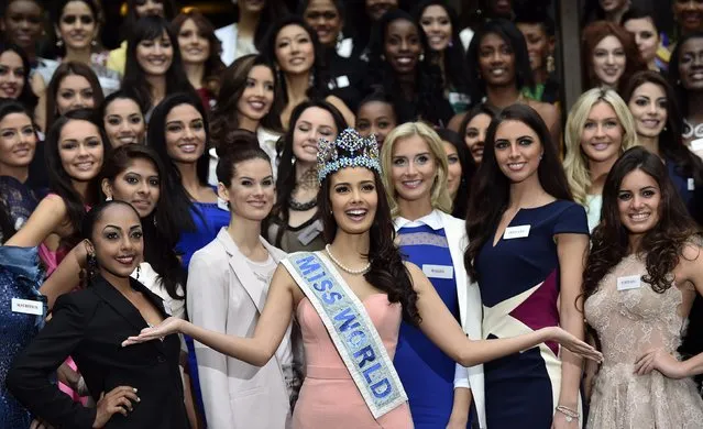 Miss World 2013, Megan Young of the Philippines (C), poses with 2014 event finalists during a publicity launch in central London November 25, 2014. (Photo by Toby Melville/Reuters)