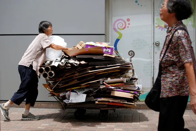 A woman collects cardboard on a street in Hong Kong, China September 15, 2017. (Photo by Bobby Yip/Reuters)