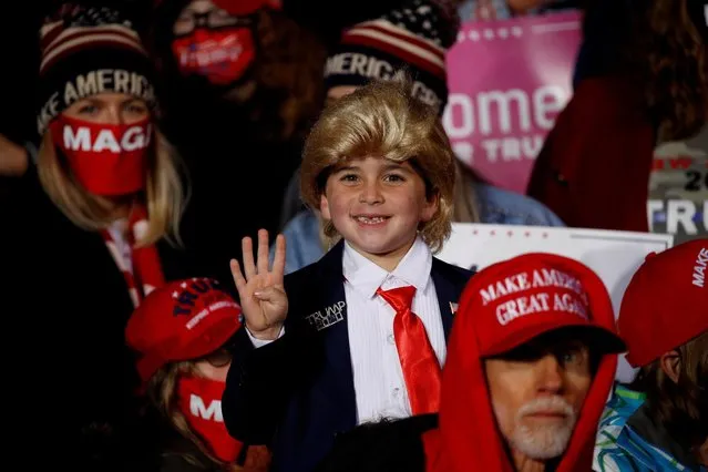A boy in the audience gives a thumbs-up during U.S. President Donald Trump's campaign rally at Erie International Airport in Erie, Pennsylvania, U.S., October 20, 2020. (Photo by Tom Brenner/Reuters)